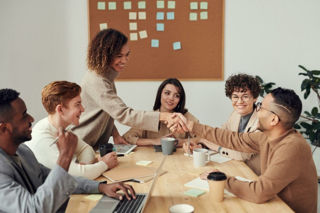 People Shaking Hands In An Office Setting