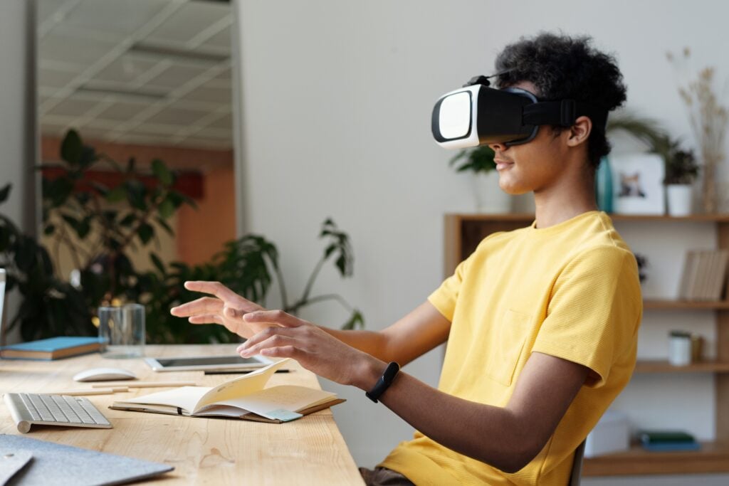 A Person Wearing And Testing Vr Glasses At A Desking