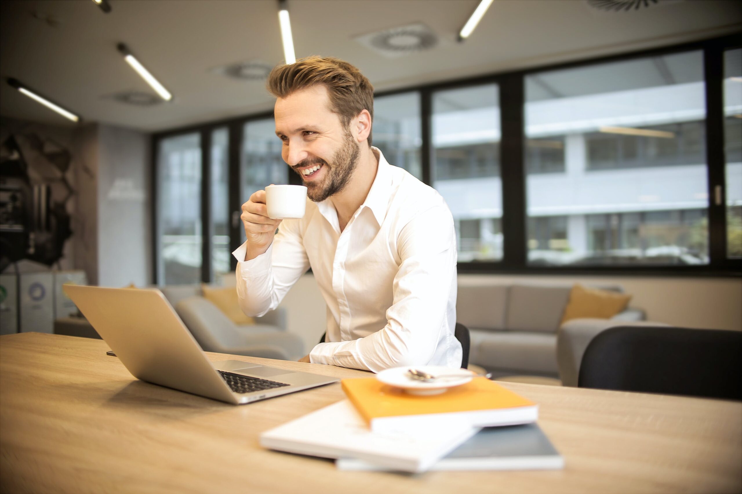 Man Smiling At A Desk Creating Dynamics 365 C