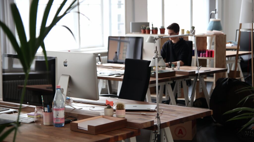 People Working On Computers In A Light Office Space